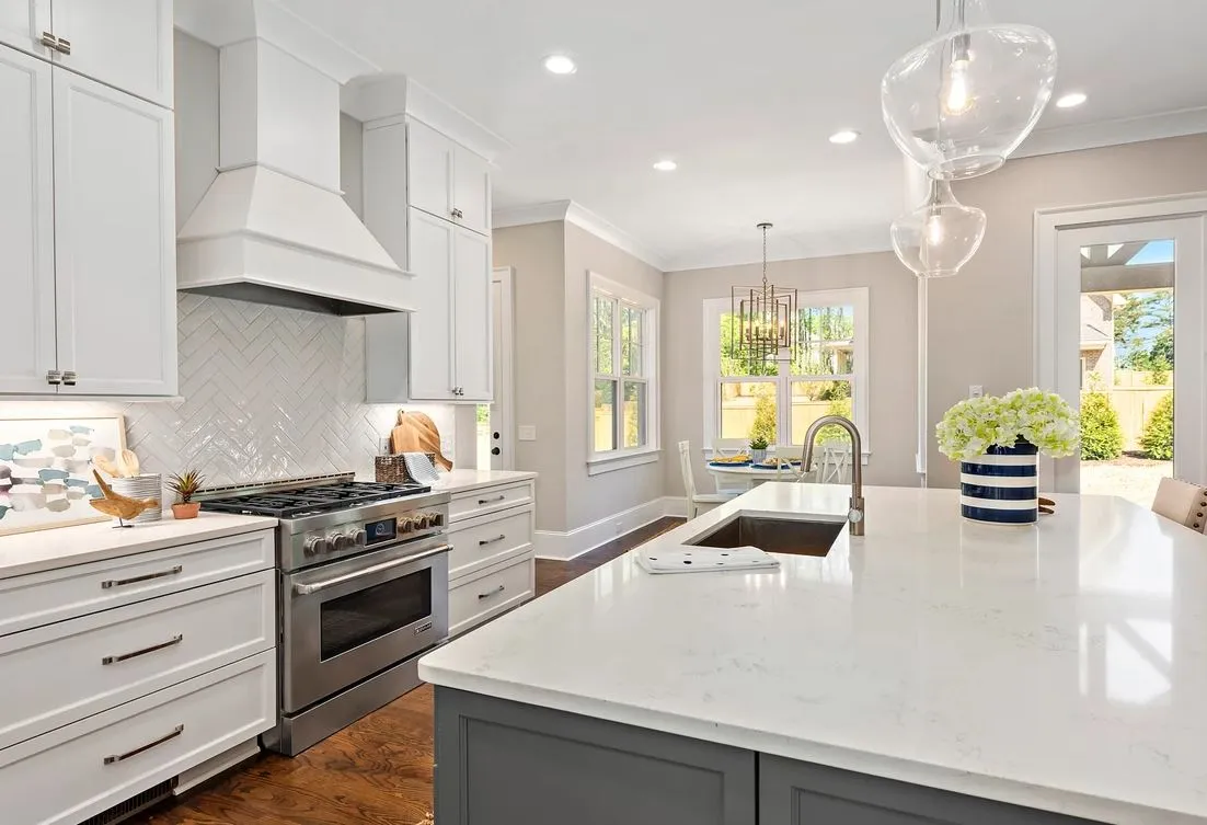 white kitchen with wooden flooring