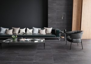 a living room with black tiles and flooring
